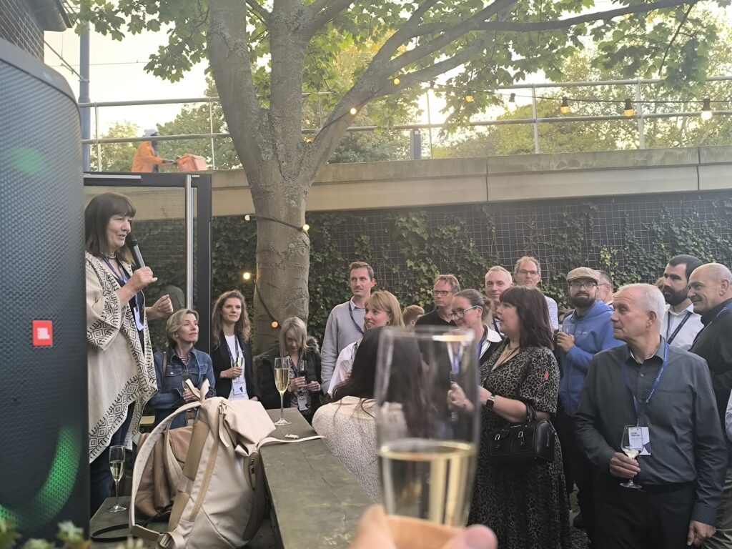 📸 Gill Ferrell, directora ejecutiva de 1EdTech, ofreciendo un discurso-brindis para los asistentes durante la cena en el jardín del Vakwerkhuis.